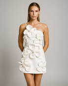 White floral mini dress worn by a model on a gray background
