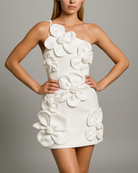 White floral mini dress worn by a model on a gray background